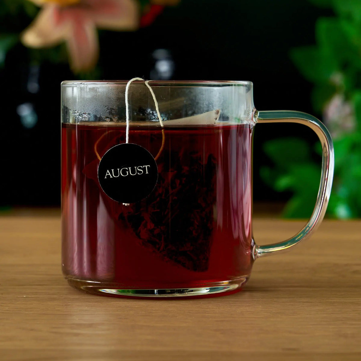 Jet Black tea brewed in a clear glass mug with the tea bag steeping, Da LBI Tea